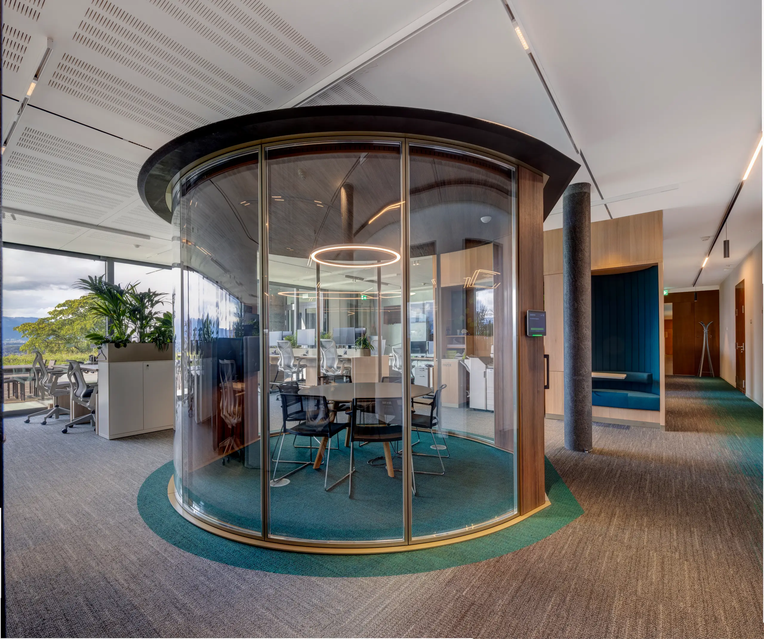 Cluster of enclosed work pods offering quiet, bookable focus space within the open floor