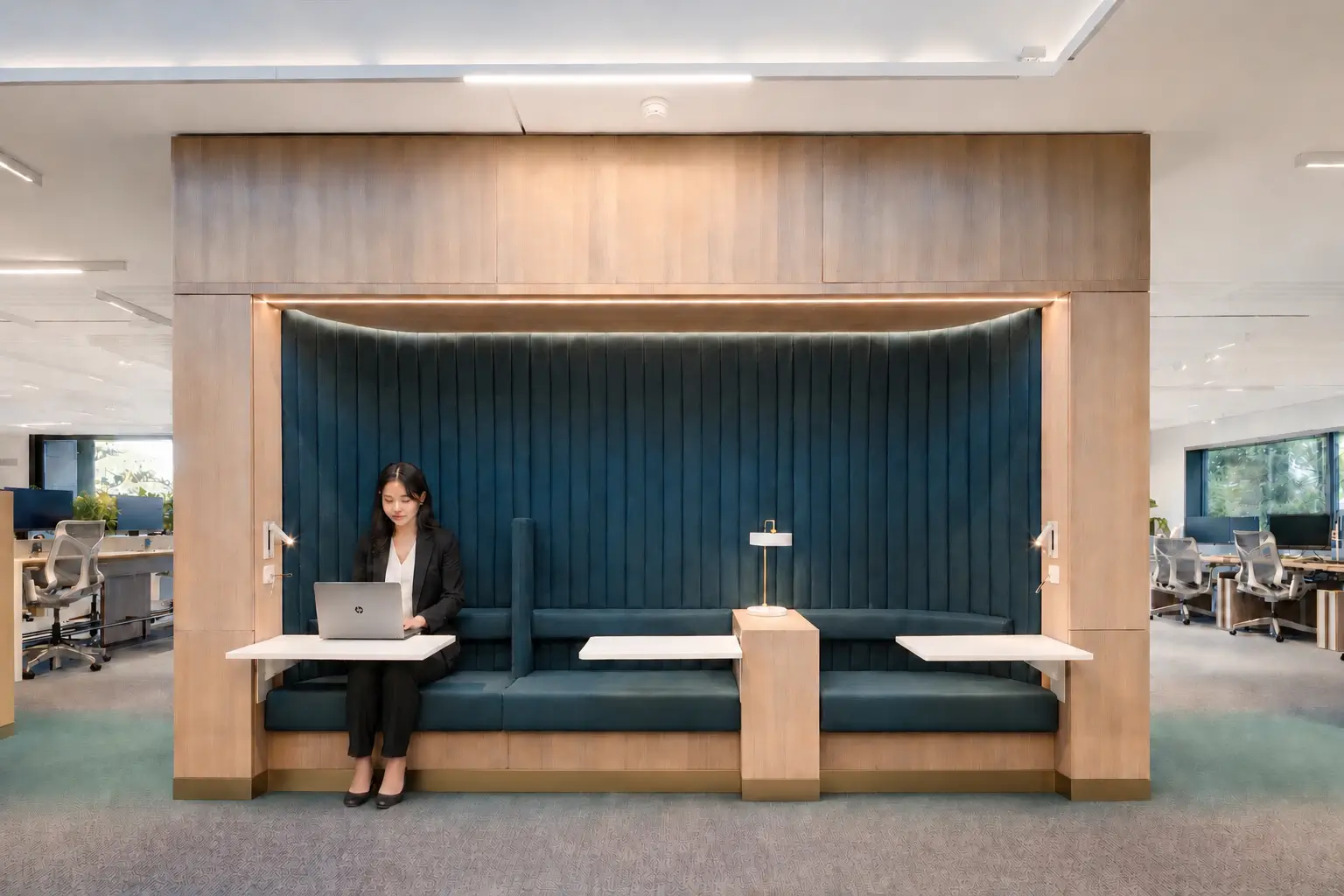 The custom Hotdesk element set into a circulation route, framed in oak with integrated screening